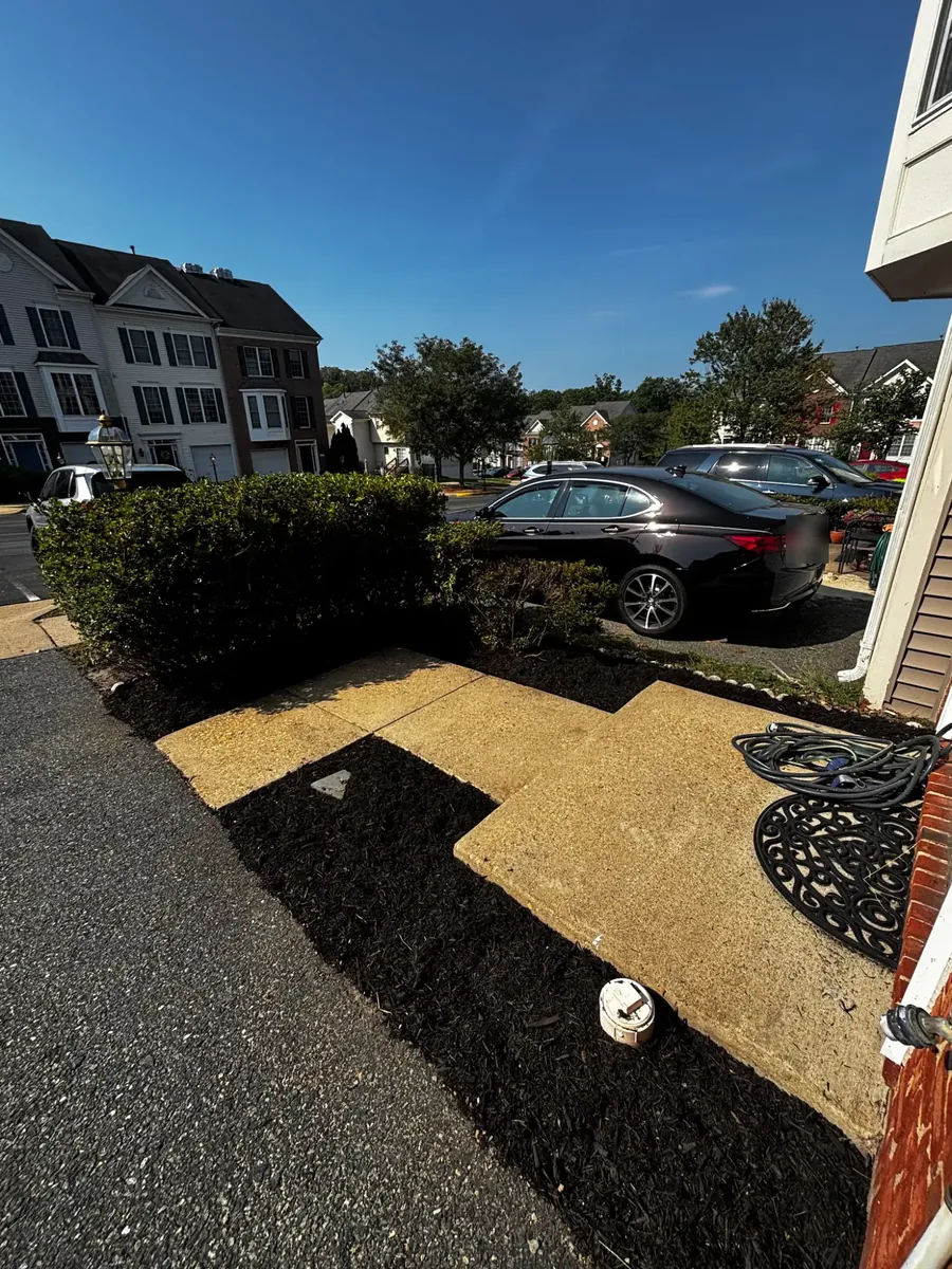 The same front bed after weeding and edging, finished with fresh black mulch